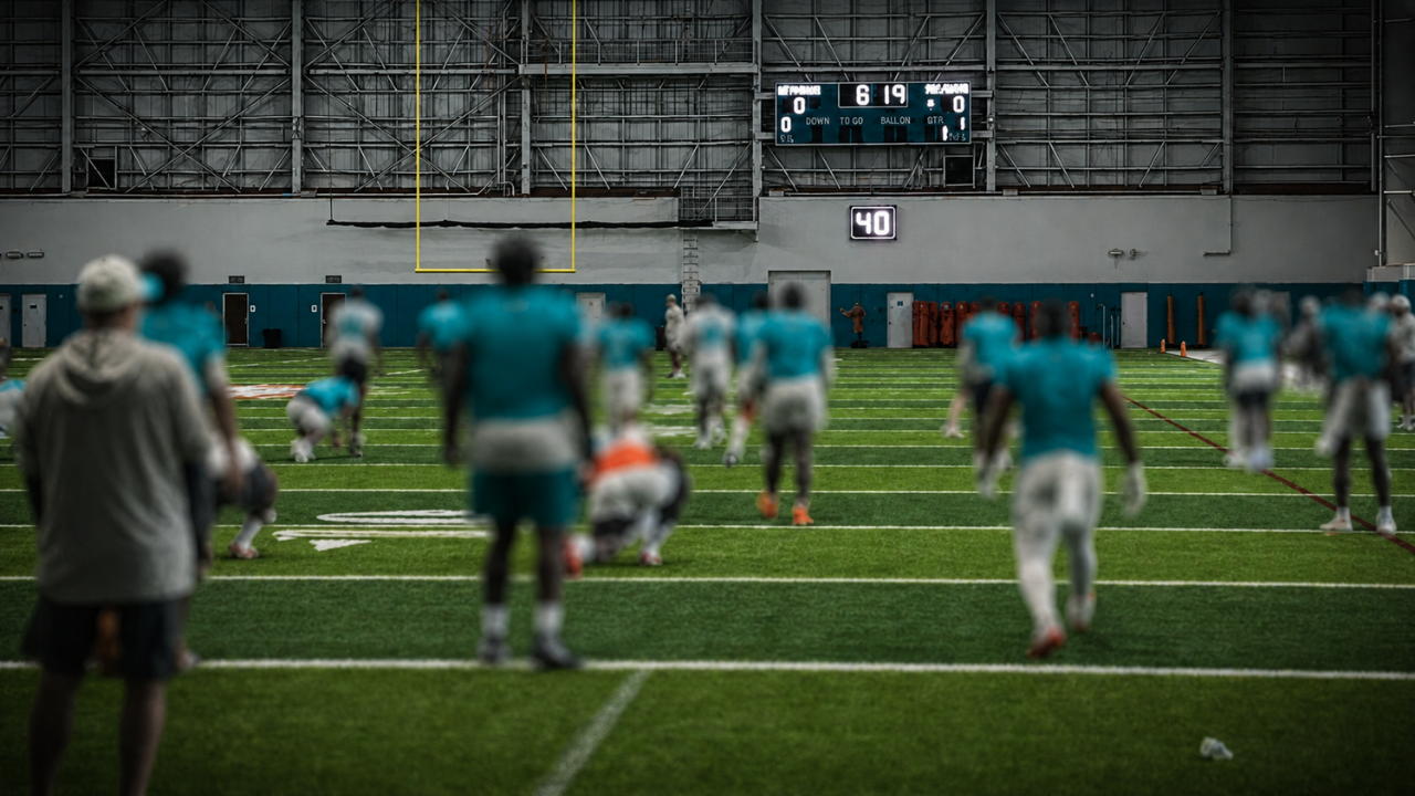 Blurred Miami Dolphins players practicing ahead of the 2026 roster cut deadline
